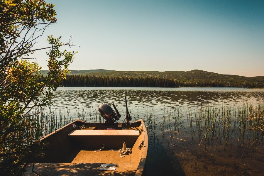 A canadian lake with a boat in foreground