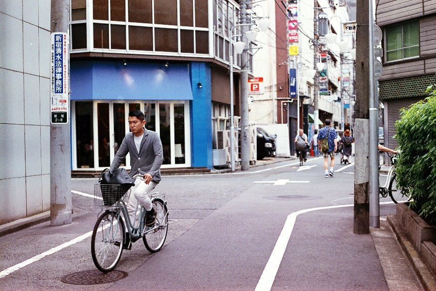 Man on a bicycle on a narrow Tokyo street