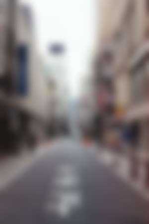 A tokyo street surounded by high rise buildings 