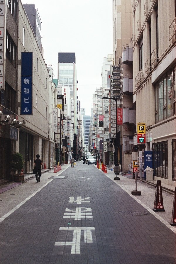 A tokyo street surounded by high rise buildings 